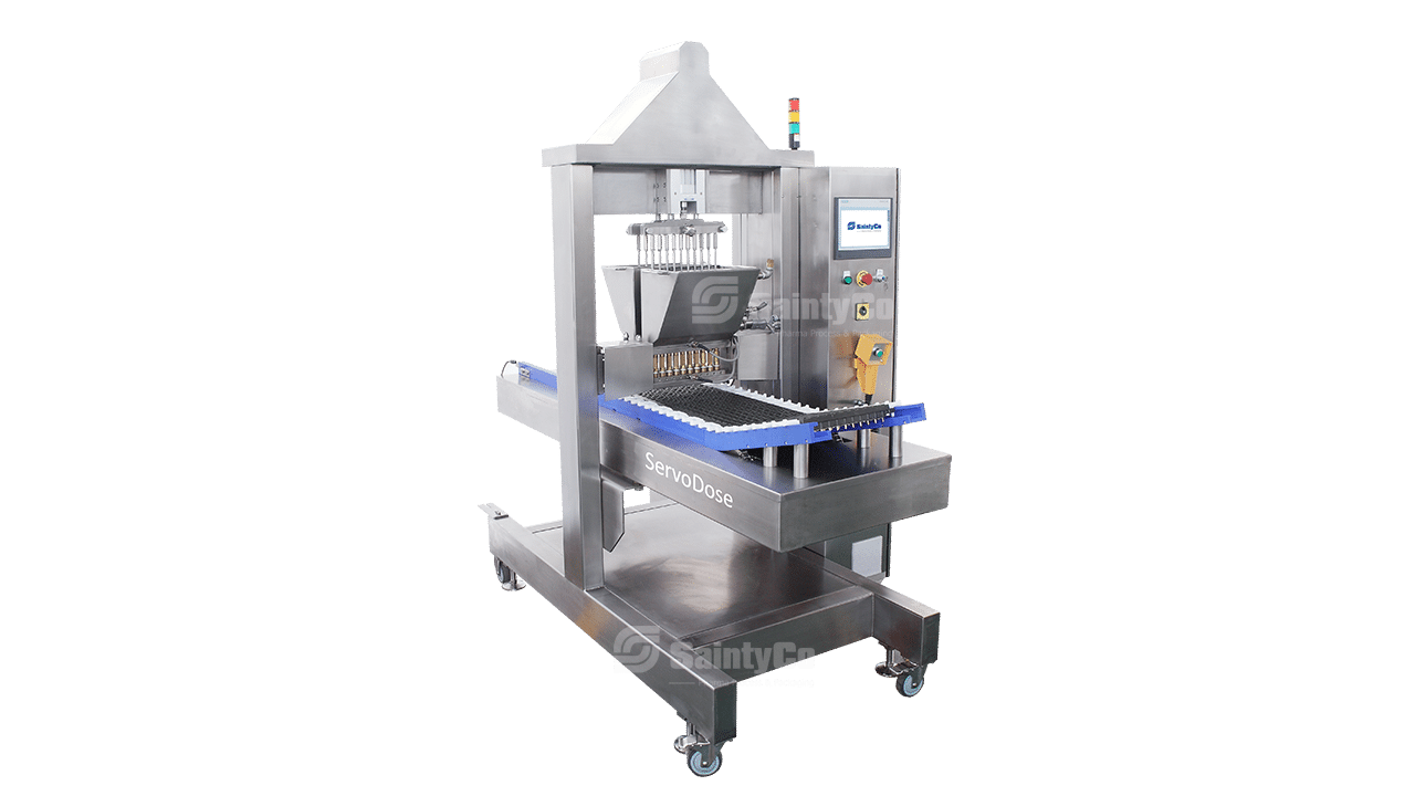 Introducing the ServoDose, a stainless steel industrial food processing machine designed for gummy manufacturing. Equipped with syringes and nozzles for precise dosing, this gummy depositor features an automated control panel on the right. Mounted on a wheeled frame, it's perfect for easy mobility in any production setting.