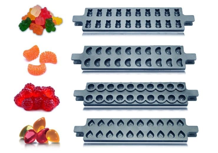 Five gray silicone candy molds from GummyGenix with various shapes are displayed vertically. From top to bottom: bear shapes, half-moon shapes, circle shapes, and teardrop shapes. Beside each mold are examples of gummies made with them: bears, orange slices, raspberries, and teardrops.