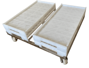 A metal trolley with four caster wheels holds two large, perforated white plastic trays designed for gummy manufacturing equipment. The trays have handles on the shorter sides for ease of carrying and feature a textured surface with small holes for ventilation or drainage.