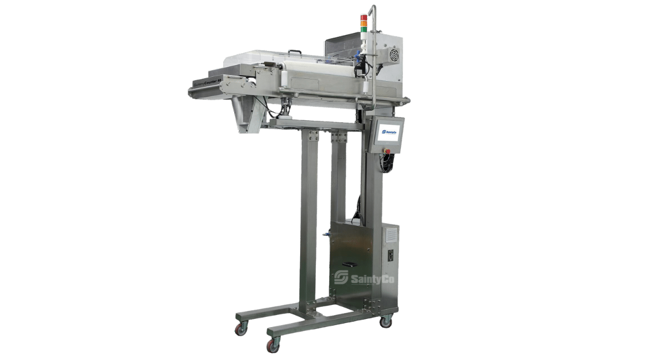 A stainless steel industrial packaging machine with a conveyor belt, control panel, and height-adjustable stand. It has wheels for mobility and appears designed for handling and sealing products in a manufacturing setting. Specifically crafted by SaintyCo, it excels in packaging items like gummy candies.