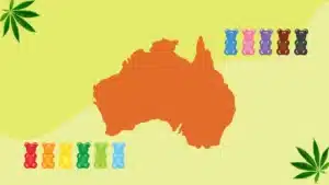 A map of Australia is surrounded by colorful gummy bears. On the left are red, orange, yellow, green, and blue gummies, and on the right are blue, pink, purple, brown, and black gummies. Cannabis leaves are in the top left and bottom right corners.