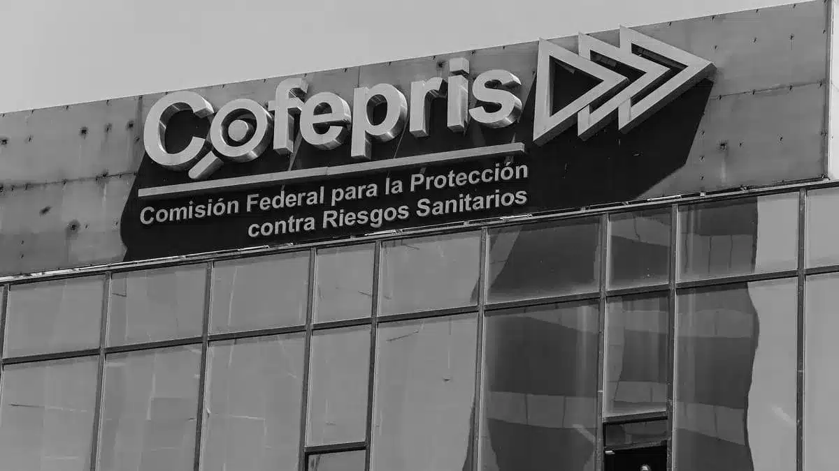 A black and white image of the Cofepris building. The sign reads 