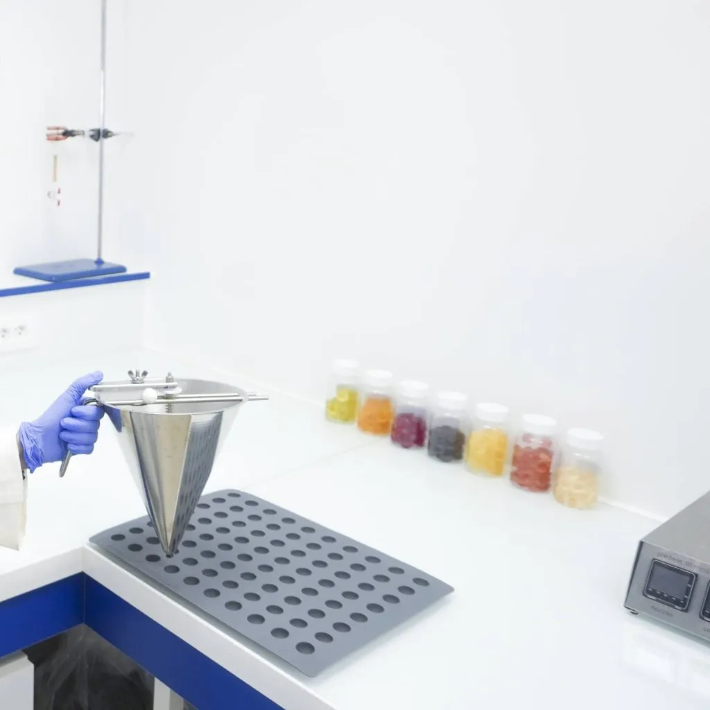 A researcher tests with gummy supplements on the table