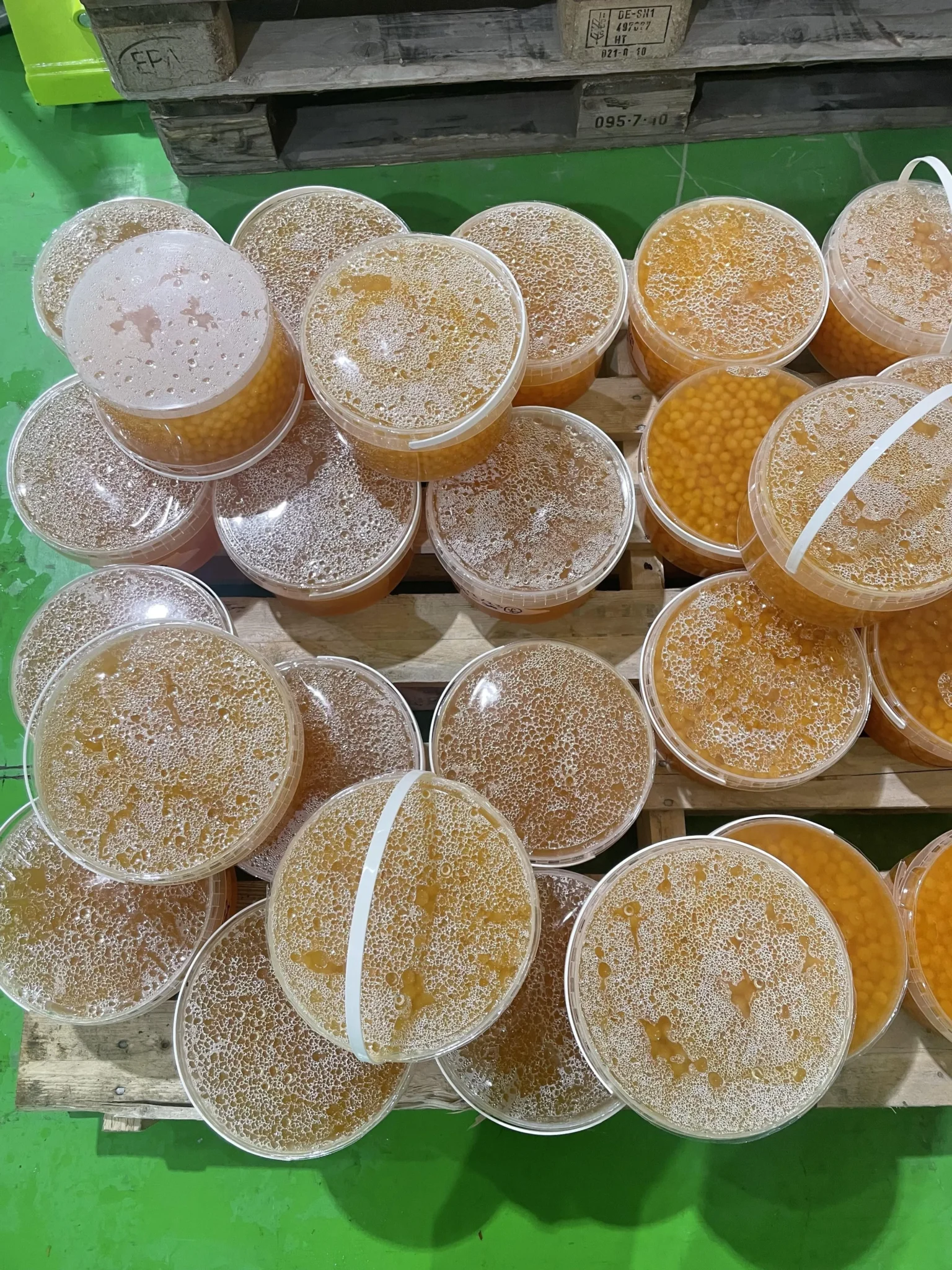 Close-up of a transparent vacuum-sealed package of popping boba with colorful juice-filled spheres